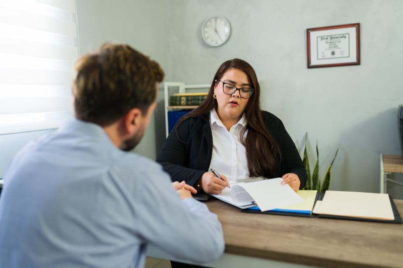 A Fords Daly Legal solicitor meeting with a client to discuss their Will in a comfortable office setting