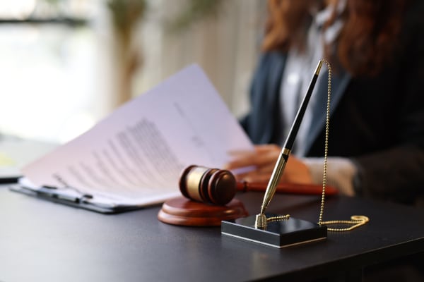 Legal documents and pen on a professional desk, representing the different types of Power of Attorney available in Scotland