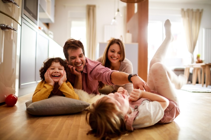 A modern family enjoying time together at home, representing the diverse family situations that benefit from careful Will planning