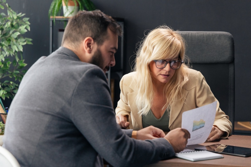 Solicitor explaining the commercial property sale process to a client in a professional meeting